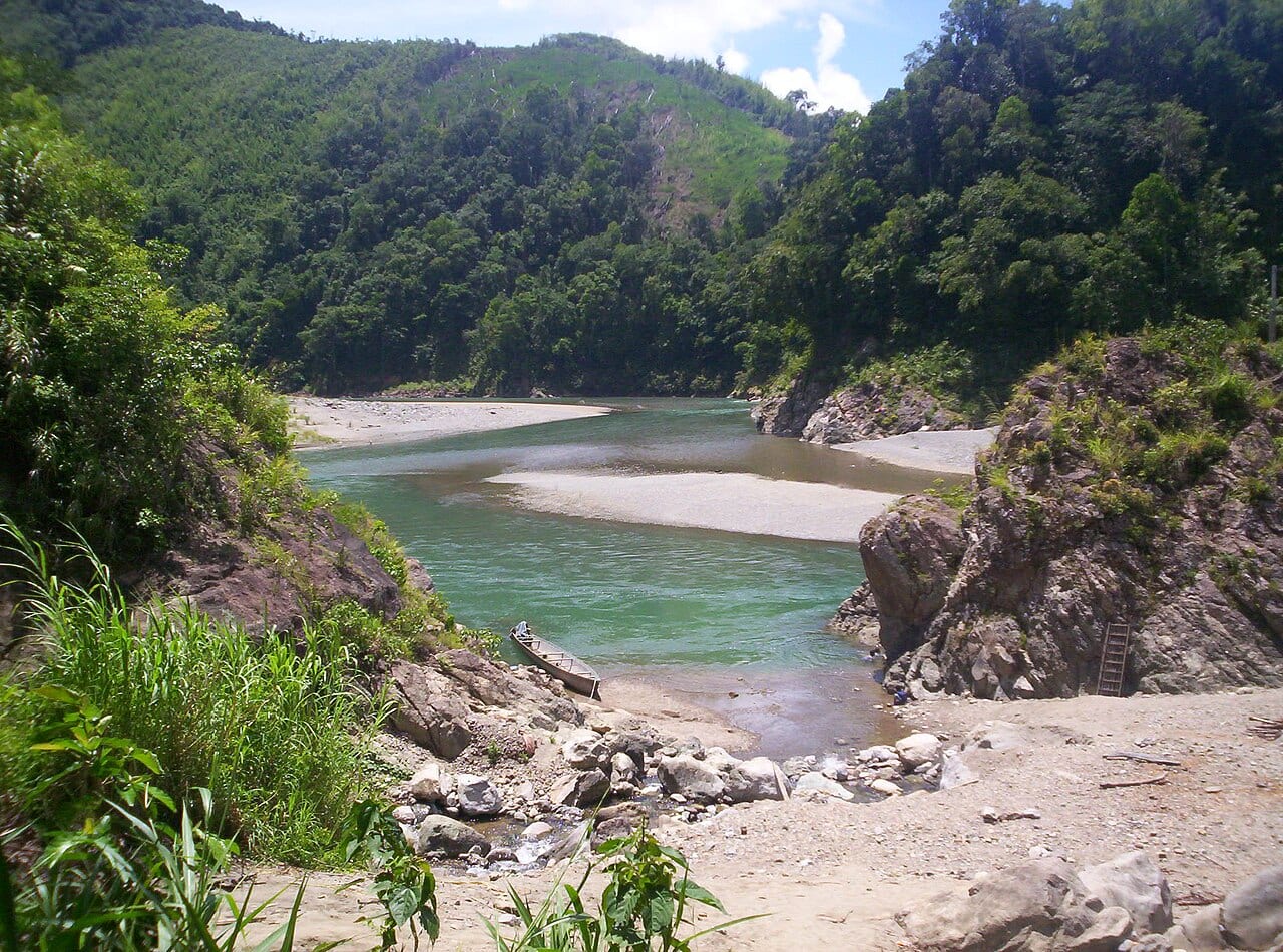 The Apayao river winding between forested Cordillera mountains at Barangay Dibagat, Kabugao